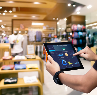 Retail associate checking stock levels on a tablet in a clothing store